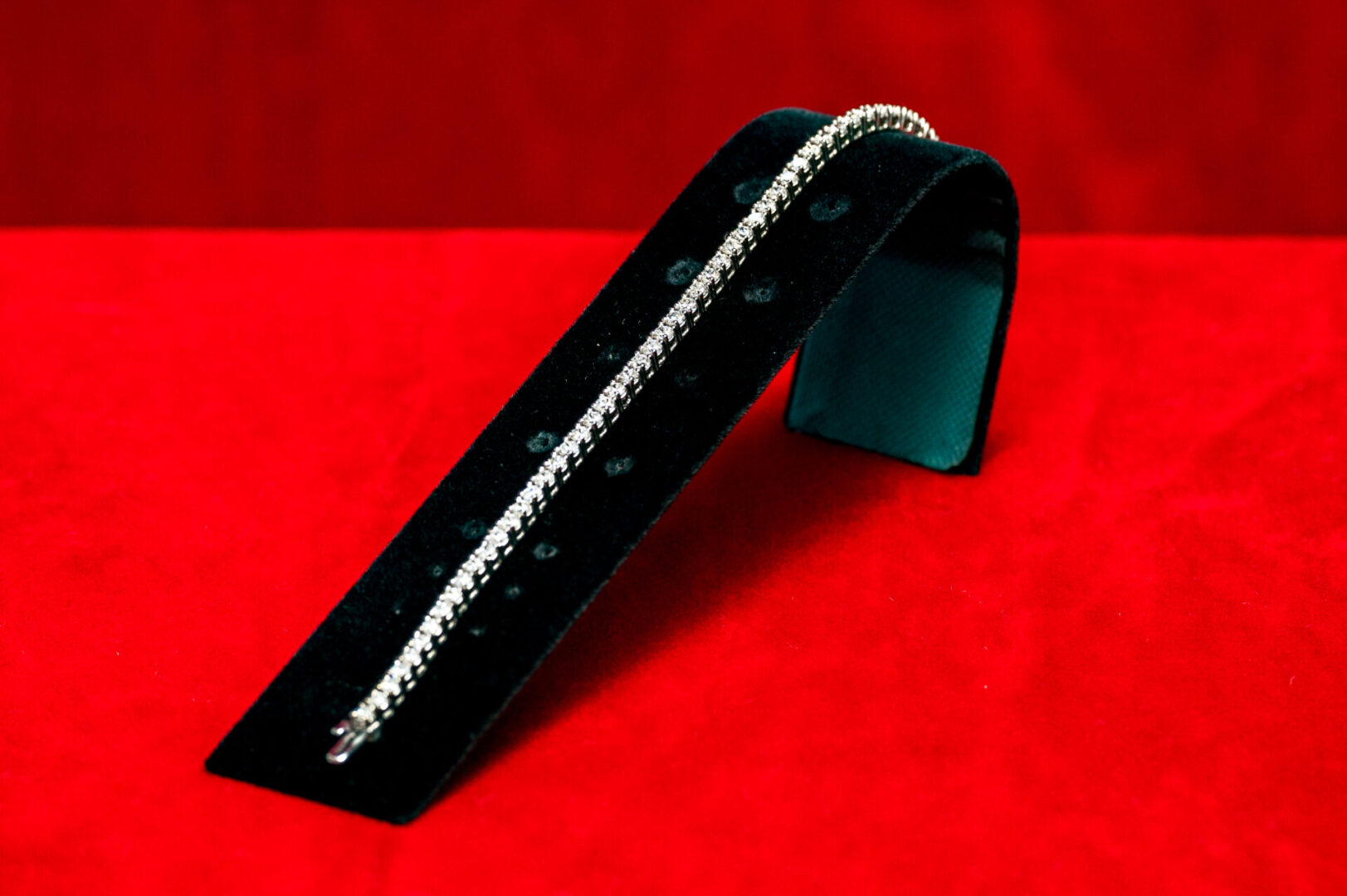 A black metal object with a long chain on it.
