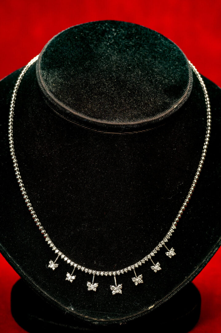 A necklace is displayed on top of a black velvet display.